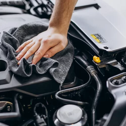 man-polishing-car-inside-car-service